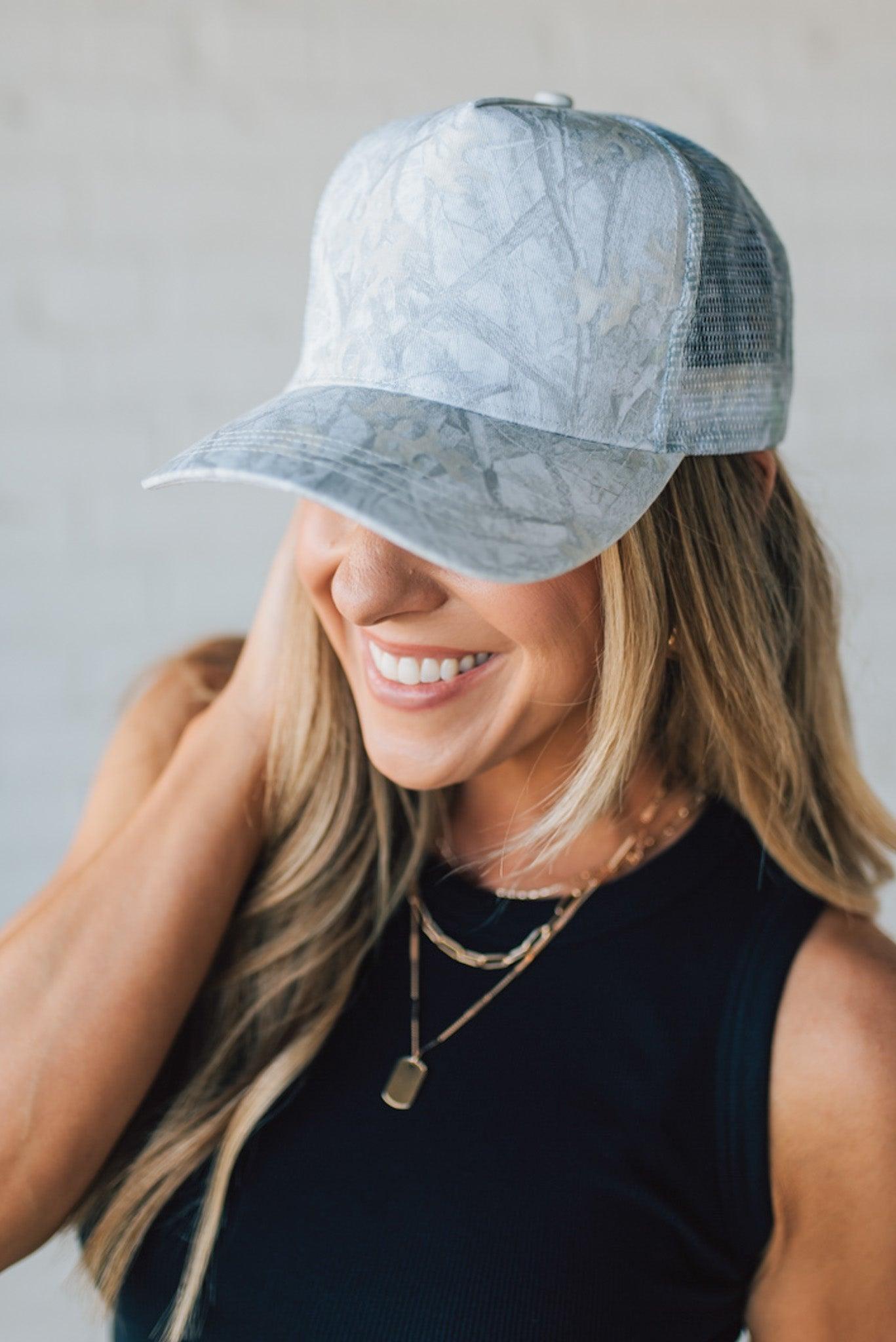 Blonde Woman Wearing a White Woods Print Mesh Back Trucker Cap.