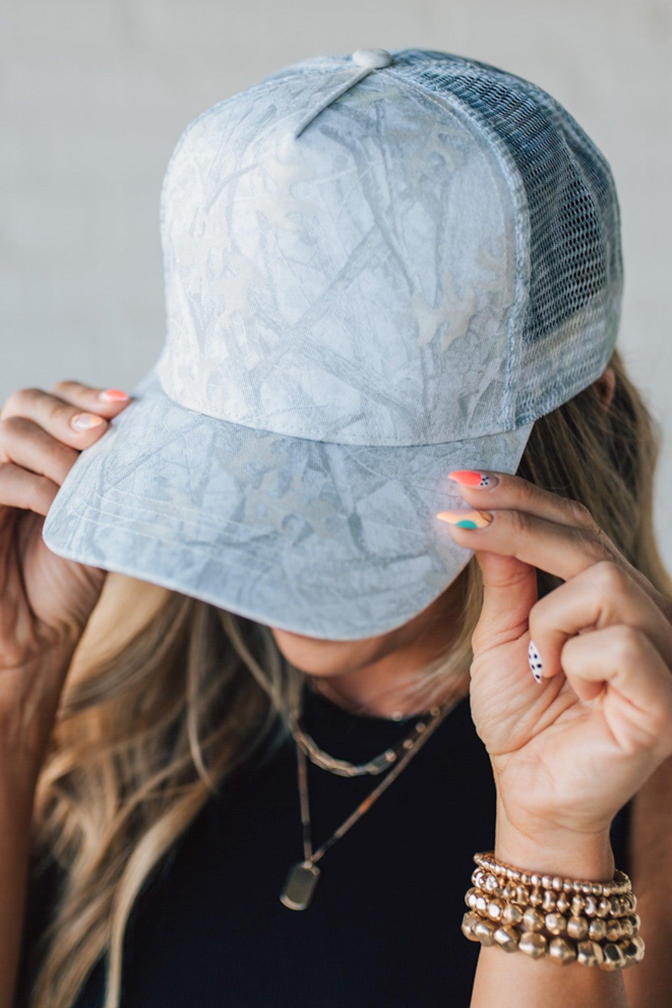 Blonde Woman Wearing a White Woods Print Mesh Back Trucker Cap.