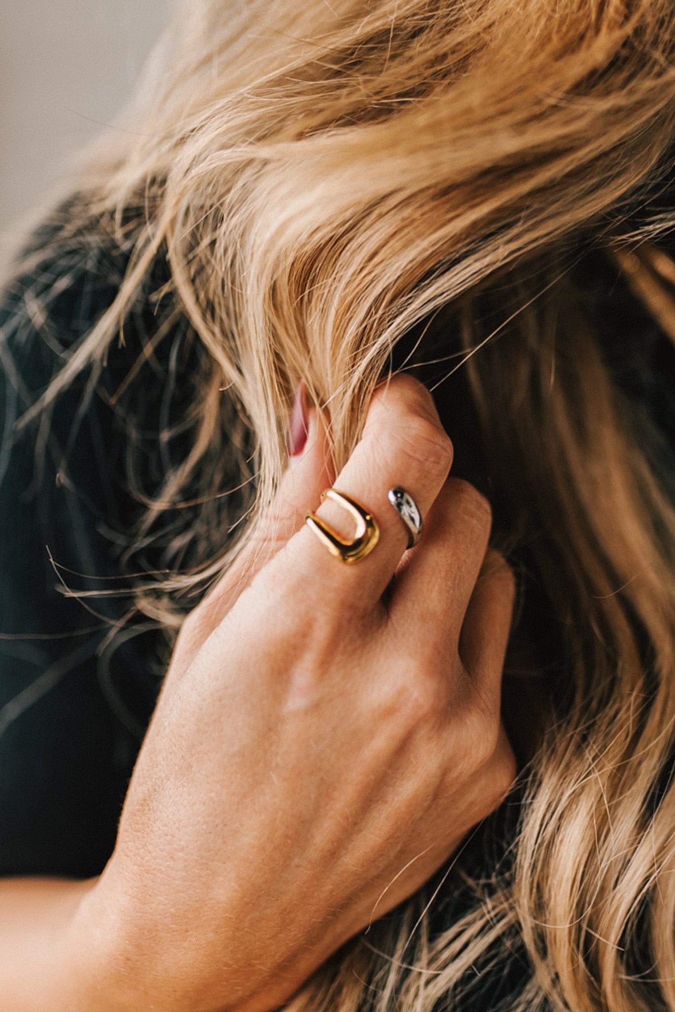 Woman modeling a two toned gold and silver wrap style ring