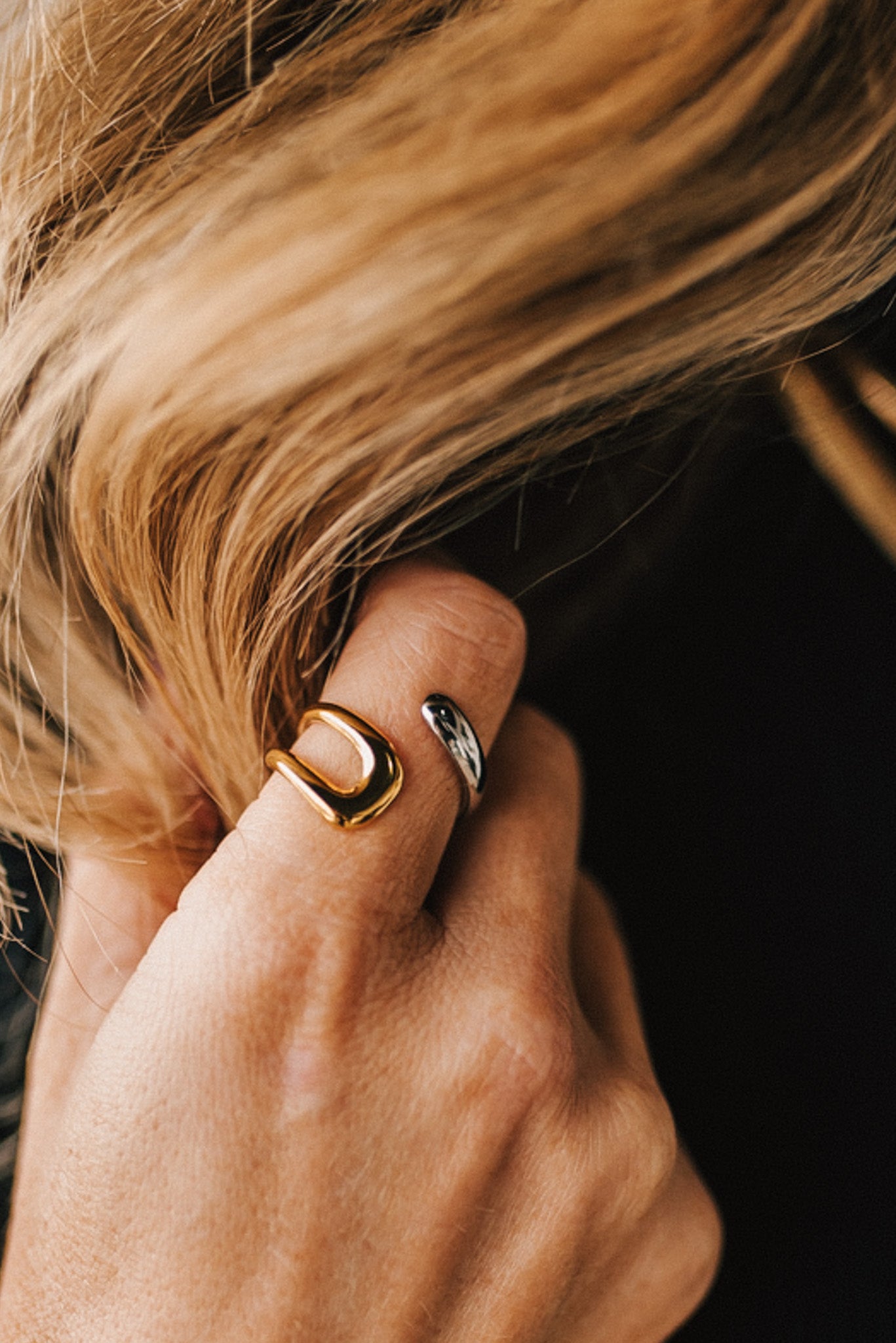 Woman modeling a two toned gold and silver wrap style ring