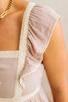 Close-up of a beige lace-trimmed top with a blurred background
